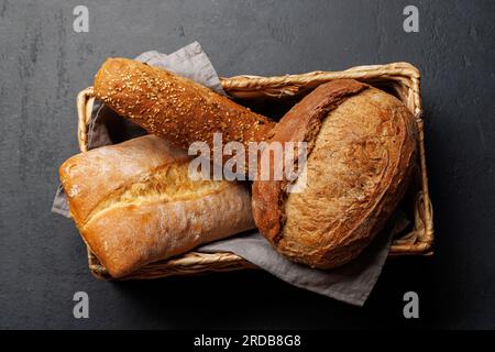 Assorted bread varieties in a charming basket, ready to be enjoyed. Flat lay Stock Photo