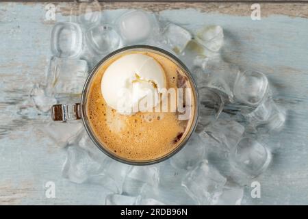 Affogato coffee with vanilla ice cream in a glass cup on wooden table Stock Photo