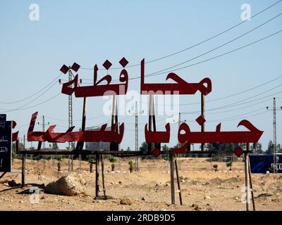 South Sinai, Egypt, June 30 2023: Translation of Arabic text (South Sinai Governorate City) near Ras Sedr city at Sharm El Sheikh international road, Stock Photo