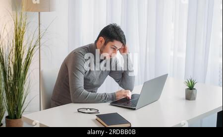 Work pressure exhausted employee man laptop office Stock Photo