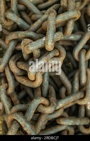 Rusty chain on the ground, close up of photo. Stock Photo