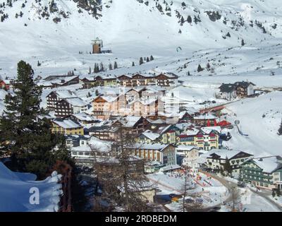 Obertauern, Austria: 11 January 2008: View from the ski slope to the valley of Obertauern with all its hotels and restaurants covered with snow and su Stock Photo