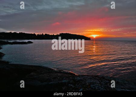 Sunrise over the lake Vänern with the sky and Water being beautifully floodlit Stock Photo
