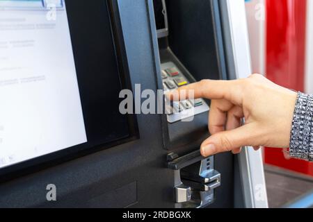 close-up shot of woman using ATM keypad Stock Photo