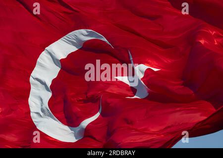 Turk Bayragi or Turkish Flag. Waving Turkish flag in full frame view. National holidays of Turkiye concept photo. Stock Photo