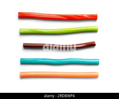 Jelly gummy candies in the form of sticks of different colors on a white background, top view Stock Photo