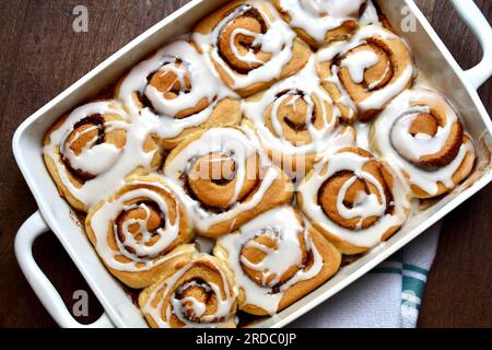 Cinnamon rolls in an oblong white baking dish viewed from above Stock Photo