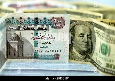 American and Egyptian money banknotes , pile of old vintage retro 100 One hundred American dollars bill with stack folded EGP Egyptian pounds LE, mone Stock Photo