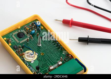Interior of the integrated circuit of a tester with the black and red test leads on white Stock Photo