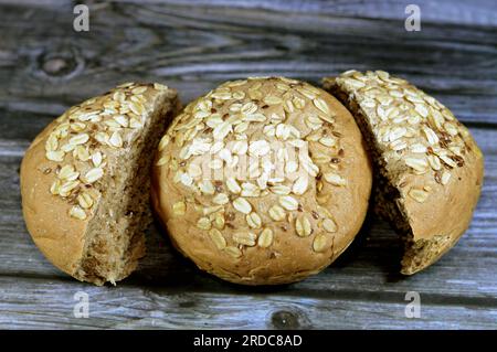 wheat oat fresh baked bun topped with oats and sesame, The oat (Avena sativa), sometimes called the common oat, species of cereal grain grown for its Stock Photo