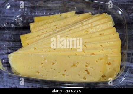 Slices of Egyptian Rumi cheese, also called gebna romiya or gebna turkiya, Roumi, Romi also Romy, middle Eastern parmesan hard cheese, has a pungent s Stock Photo