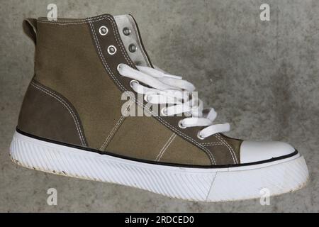 A classic in fashion, canvas sneaker with a white rubber toe before the classic in construction, concrete. Stock Photo