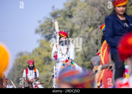Camel Festival, Portrait of an young rajasthani male with beard and moustache wearing white traditional rajasthani dress and turban. Stock Photo