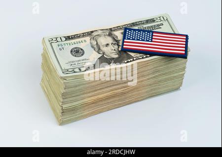 American flag on pile of 20 dollar banknote isolated on white studio background Stock Photo