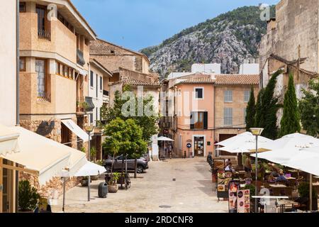 Cozy little square with small shops and terraces in the charming mountainous village in the north of the Mediterranean island of Mallorca in Spain. Stock Photo