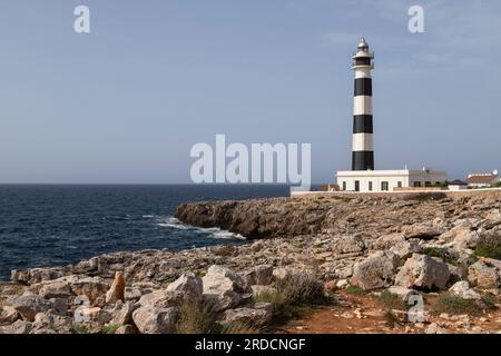 Cap d'Artrutx lighthouse near the town of Cala en Bosch in the southwest of the Spanish island of Menorca. Stock Photo