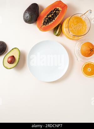 exotic fruits and juice, empty plate on background Stock Photo