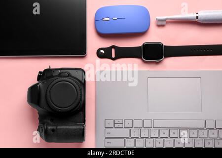 Modern gadgets on pink background Stock Photo