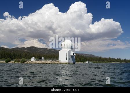 The Solar Observatory in Big Bear Lake, California, shown on a sunny afternoon with big, puffy clouds. Stock Photo