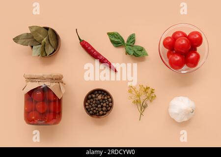 Jar with canned tomatoes and ingredients on brown background Stock Photo
