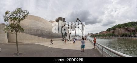 Bilbao Spain - 07 05 2021: Panoramic exterior view at the iconic Guggenheim Museum Bilbao, Maman spider sculpture, iconic museum of modern and contemp Stock Photo
