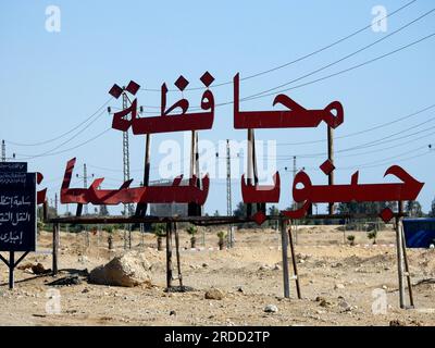 South Sinai, Egypt, June 30 2023: Translation of Arabic text (South Sinai Governorate City) near Ras Sedr city at Sharm El Sheikh international road, Stock Photo