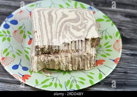 Traditional tahini halva with chocolate or Halawa Tahiniya, the primary ingredients in this confection are sesame butter or paste (tahini) sugar, gluc Stock Photo