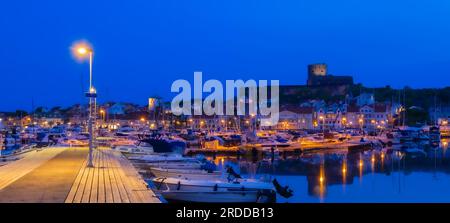 The port and a blue hour view at the castle of a small island and town of Marstrand, located in the municipality of Kungalv in southern Bohuslan, on t Stock Photo