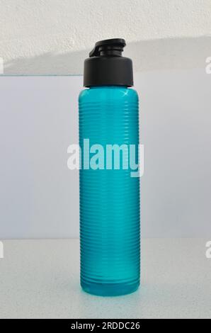 Detailed close-up of a blue water bottle, perfect for accompanying workouts. Essential hydration for peak performance. Stock Photo