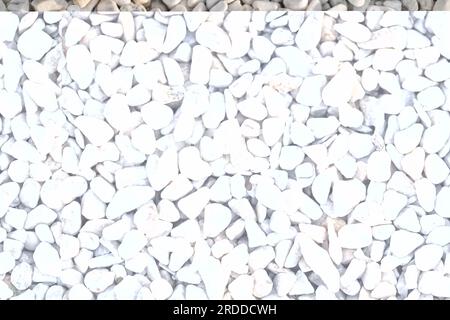 Texture of white pebbles. Small stones on the ground for landscape design. Pure white gravel close-up as background. Stock Photo
