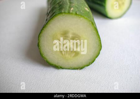 Fresh, raw green Persian cucumbers, grown organically. Presented on a white background for a clean and natural look. Stock Photo