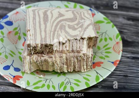 Traditional tahini halva with chocolate or Halawa Tahiniya, the primary ingredients in this confection are sesame butter or paste (tahini) sugar, gluc Stock Photo