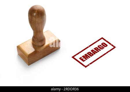 Economic sanctions. Wooden stamp and red mark Embargo on white background Stock Photo