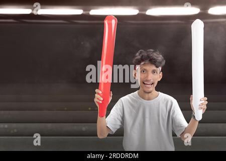 Indonesian man supporting the team when competing. Indonesian independence day Stock Photo