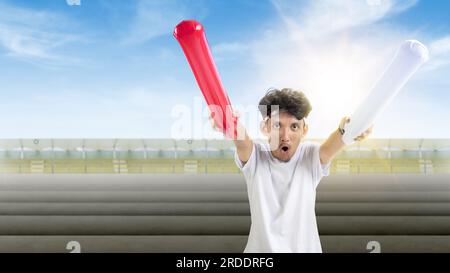 Indonesian man supporting the team when competing. Indonesian independence day Stock Photo