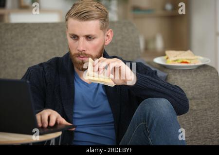officer having lunch while working from home Stock Photo