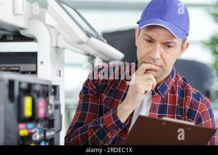 technician is checking and changing the printer equipment cartridges Stock Photo