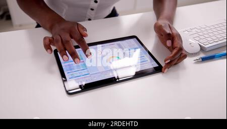 African American Spreadsheet Data Analyst Using Computer Software Stock Photo