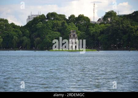 Turtle Tower, built between 1884 and 1886 on an islet in the middle of the lake. The tower has a rectangular structure and three storeys, with each upper storey bigger than the one directly below it. Hoàn Kiếm Lake, also known as Sword Lake or Tả Vọng Lake, is a fresh water lake, in central Hanoi, the capital city of Vietnam ,Asia; in past, the lake had been titled: 'Lục Thủy Lake' or 'Thủy Quân Lake' Stock Photo