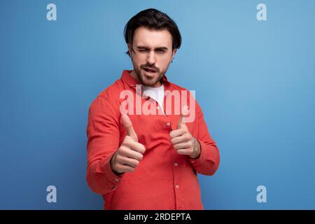 attractive brutal dark-haired 30s man in a red shirt Stock Photo