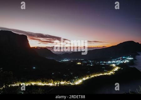 Cemoro Lawang village near Gunung Bromo or Mount Bromo with lights at dawn or sunrise viewed from Seruni Sunrise Point Stock Photo
