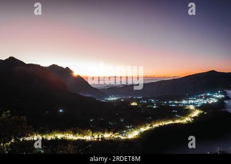 Cemoro Lawang village near Gunung Bromo or Mount Bromo with lights at dawn or sunrise viewed from Seruni Sunrise Point Stock Photo