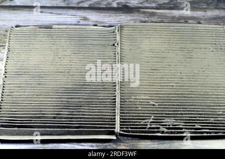 old dirty used car AC air conditioning filter full of dust removed from the vehicle to be replaced with a new one, cabin air carbon filter, rectangula Stock Photo