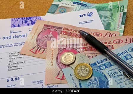 Household bill costs telephone, internet, BT in Northern Ireland, Sterling notes, coins, increased poverty caused by inflation Stock Photo