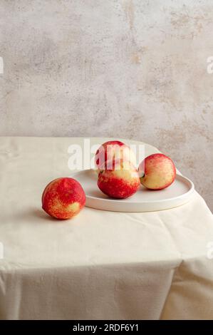 honey peach in wooden bowl on white background Stock Photo