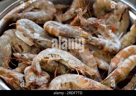 Pile of raw frozen shrimps, a crustacean (a form of shellfish) with an elongated body and a primarily swimming mode of locomotion, Caridea or Dendrobr Stock Photo