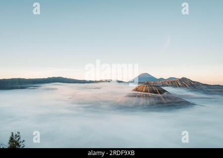 Gunung Bromo or Bromo Mountain is covered by clouds in the morning with clear blue sky Stock Photo