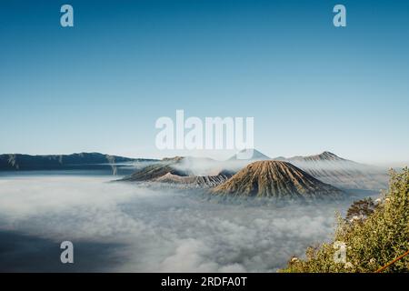 Gunung Bromo or Bromo Mountain is covered by small amount of clouds in the morning with clear blue sky Stock Photo