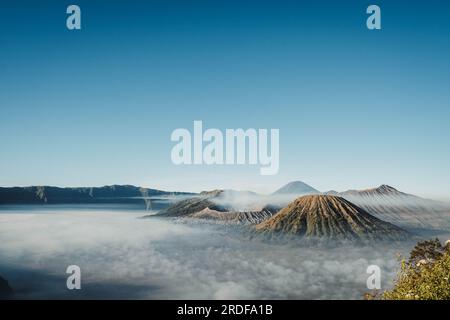 Gunung Bromo or Bromo Mountain is covered by small amount of clouds in the morning with clear blue sky Stock Photo