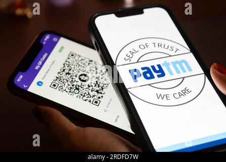 In this photo illustration, the Paytm logo and PhonePe QR code, is seen displayed on mobile phones screen in Guwanati, India on 19 July 2023. Stock Photo